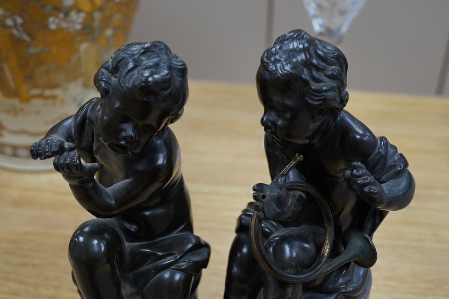 A pair of 19th century French bronze figures of children playing instruments, raised on rouge marble columns, 23cm high. Condition - poor